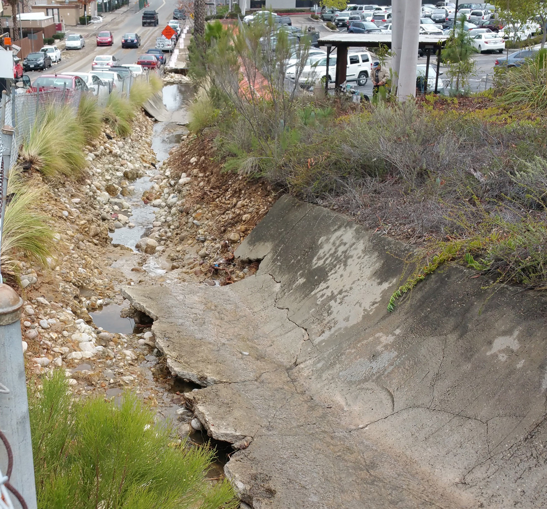 A cracked and crumbling stormwater channel